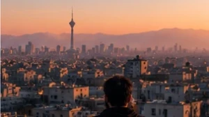 City rooftops and misty mountains in early morning light
