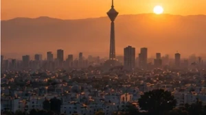 A Tehran-like skyline with a tall tower and an arched monument in golden evening light